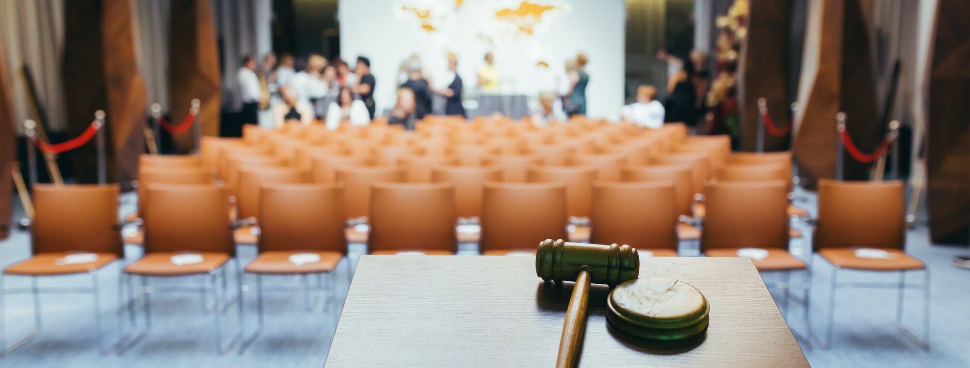 Hammer for the auction, on the background of the conference hall